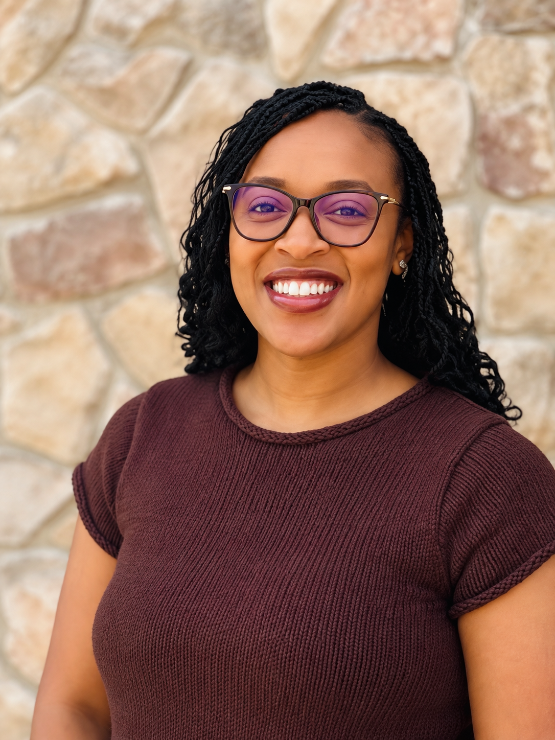 KeShana Johnson smiling, wearing glasses and a burgundy top